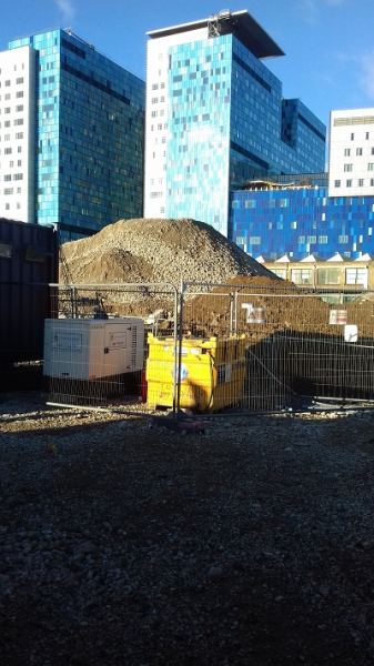 Figure 4. Spoil heap of archaeological activities from a site in Whitechapel, east London, against the background of Whitechapel Hospital (Personal Archive 2018).